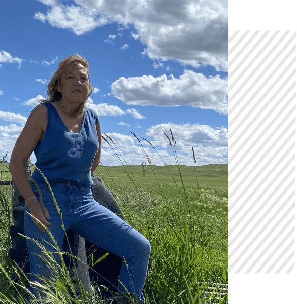 A woman in blue is sitting on the grass