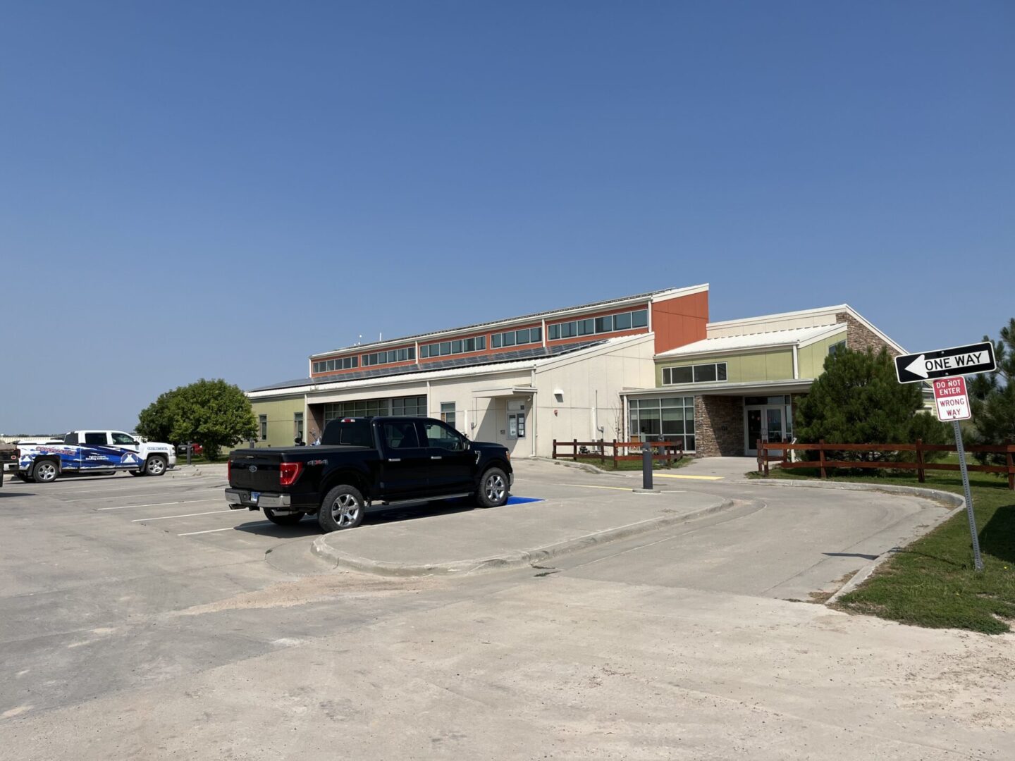 A black truck parked in front of a building.